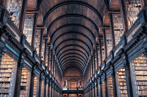 arched hallway of a library with stack shelfs along the sides